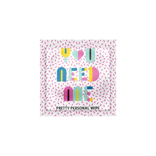 Personal wipe packaging with colorful text and a pink pattern on a white background