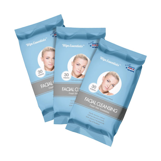 Three pouches of Wipeessentials Oil Free Facial Cleansing Wipes, with a image of a woman on each pouch and text indicating the product is facial cleansing wipes with 30 counts per pouch.